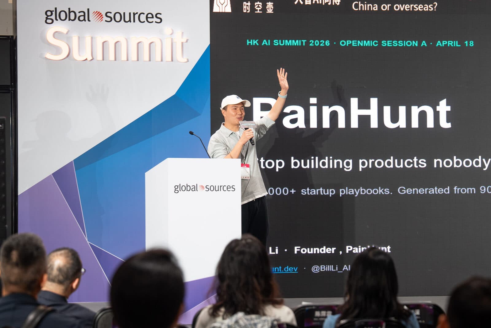 Bill Li on stage at HK AI Summit 2026 — PainHunt slide visible